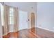 Foyer with hardwood floors, a front door, a window with curtains, and an arched doorway at 4227 Bethpage Ct, Wesley Chapel, FL 33543