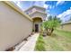 Inviting front entrance with a walkway, charming landscaping, and an arched doorway at 4227 Bethpage Ct, Wesley Chapel, FL 33543