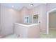 Hallway featuring neutral walls and a balcony overlooking the house at 4227 Bethpage Ct, Wesley Chapel, FL 33543