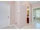 Hallway view with a door to the bathroom and a glimpse of the laundry room with machines at 4227 Bethpage Ct, Wesley Chapel, FL 33543