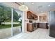 Lovely kitchen with stainless appliances, cabinets, and sliding glass door to backyard at 4227 Bethpage Ct, Wesley Chapel, FL 33543