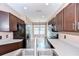 Well-lit kitchen featuring stainless steel appliances and plentiful cabinet space at 4227 Bethpage Ct, Wesley Chapel, FL 33543
