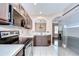 Modern kitchen boasts stainless steel appliances, dark wood cabinets, and an open layout at 4227 Bethpage Ct, Wesley Chapel, FL 33543