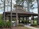Shaded community picnic pavilion with stone accents, mature trees, and covered picnic tables at 4227 Bethpage Ct, Wesley Chapel, FL 33543