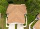 Aerial view of a home featuring a manicured lawn, complemented by verdant landscaping at 4228 Silver Star Dr, Spring Hill, FL 34609