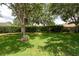 The spacious back yard is tree-lined and features manicured landscaping at 4228 Silver Star Dr, Spring Hill, FL 34609