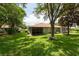 Wide backyard with a large lawn area and a lanai that provides a great outdoor space at 4228 Silver Star Dr, Spring Hill, FL 34609