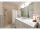 Well-lit bathroom with shower-tub combination, a large mirror, and white marble countertops at 4228 Silver Star Dr, Spring Hill, FL 34609