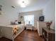 Bright bedroom featuring a twin bed, natural light, and wooden floors for a cozy atmosphere at 4228 Silver Star Dr, Spring Hill, FL 34609