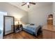 Cozy bedroom features wood floors, a twin bed, and a full-length mirror, creating a serene retreat at 4228 Silver Star Dr, Spring Hill, FL 34609