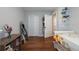 Cozy bedroom with a twin bed, wood floors, and closet space, with organized shelves at 4228 Silver Star Dr, Spring Hill, FL 34609