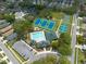 Aerial view of community amenities including a pool, tennis courts, and parking at 4228 Silver Star Dr, Spring Hill, FL 34609