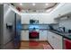 The updated kitchen offers stainless steel appliances, granite countertops, and white cabinetry at 4228 Silver Star Dr, Spring Hill, FL 34609
