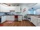 The well-lit kitchen showcases white cabinets, stainless steel appliances, and hardwood floors at 4228 Silver Star Dr, Spring Hill, FL 34609