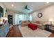 Bright living room with large windows, ceiling fan, couches, and hardwood flooring at 4228 Silver Star Dr, Spring Hill, FL 34609