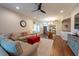 Open living room view featuring a ceiling fan, large windows, and hardwood floors at 4228 Silver Star Dr, Spring Hill, FL 34609