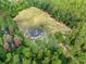 Stunning aerial view of home nestled amongst trees on large lot with expansive cleared area at 4261 Burns Rd, Brooksville, FL 34602
