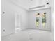 Unfinished bedroom boasts natural light from two large windows overlooking a wooded area at 4261 Burns Rd, Brooksville, FL 34602