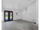 A blank canvas awaits in this empty room, featuring a concrete floor and a door to the outside at 4261 Burns Rd, Brooksville, FL 34602