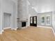Bright living room with a stone fireplace, high ceilings, and light hardwood floors offers a cozy and inviting space at 4261 Burns Rd, Brooksville, FL 34602