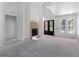 Spacious living room with fireplace, high ceilings, and natural light from large windows at 4261 Burns Rd, Brooksville, FL 34602