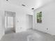An open room with a large window bringing in ample natural light and bare white walls ready for customization at 4261 Burns Rd, Brooksville, FL 34602