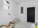 A room with a window and a black door, alongside electrical panels, showcasing a modern industrial aesthetic at 4261 Burns Rd, Brooksville, FL 34602