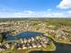 Expansive aerial view showcasing the community nestled around a peaceful lake at 4411 Whitton Way, New Port Richey, FL 34653