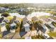 Aerial view showcasing the home's location near a lake and surrounding community at 4411 Whitton Way, New Port Richey, FL 34653