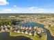 Picturesque aerial view showcasing the community nestled around a peaceful lake at 4411 Whitton Way, New Port Richey, FL 34653