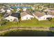 Aerial view of backyard, showcasing the home's location next to a serene lake at 4411 Whitton Way, New Port Richey, FL 34653