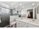 Bright bathroom featuring double sinks, sleek countertops, and a glass shower with tile at 4411 Whitton Way, New Port Richey, FL 34653