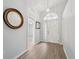 Welcoming entryway with a beautiful mirror, high ceilings, and wood-look flooring at 4411 Whitton Way, New Port Richey, FL 34653
