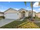 Charming single Gathering home with a well-manicured lawn and beautiful landscaping at 4411 Whitton Way, New Port Richey, FL 34653