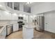 Bright kitchen boasts stainless steel appliances, granite countertops, and white cabinets at 4411 Whitton Way, New Port Richey, FL 34653