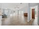 Spacious living room with wood-look floors, bright windows and a ceiling fan at 4411 Whitton Way, New Port Richey, FL 34653