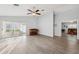 Large living room with wood-look floors and sliding doors that let in plenty of light at 4411 Whitton Way, New Port Richey, FL 34653