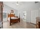 Spacious main bedroom with wood floors, walk-in closet, ceiling fan, and ensuite bathroom at 4411 Whitton Way, New Port Richey, FL 34653