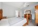 Bright main bedroom with ensuite bathroom, wood floors, ceiling fan, and closet at 4411 Whitton Way, New Port Richey, FL 34653