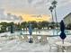 Community pool with lots of lounge chairs for relaxing and sunset view at 4411 Whitton Way, New Port Richey, FL 34653