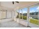 Cozy sunroom showcasing beautiful views of the pond and mature landscaping at 4411 Whitton Way, New Port Richey, FL 34653