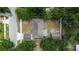 An aerial view of a home with a backyard, featuring a carport, shed, and surrounding trees at 4425 Porpoise Dr, Tampa, FL 33617