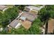Aerial view of the backyard, white fenced property, and a detached garage at 4425 Porpoise Dr, Tampa, FL 33617