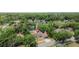 Aerial view of a house nestled among lush greenery and trees in a neighborhood setting at 4425 Porpoise Dr, Tampa, FL 33617