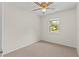 Bedroom featuring neutral walls and carpet, a gold ceiling fan, and a window view of the neighborhood at 4425 Porpoise Dr, Tampa, FL 33617