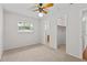 Bedroom with carpet floors, a ceiling fan, walk in closet, and a view of the en-suite bathroom at 4425 Porpoise Dr, Tampa, FL 33617