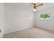 Bedroom with neutral carpet, ceiling fan, and a window providing natural light at 4425 Porpoise Dr, Tampa, FL 33617