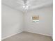 Carpeted bedroom with neutral walls, a ceiling fan, and a window overlooking the neighborhood at 4425 Porpoise Dr, Tampa, FL 33617