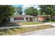 Charming one-story home with brick accents, a cozy carport, and a well-maintained lawn at 4425 Porpoise Dr, Tampa, FL 33617