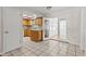 Bright kitchen with tile flooring, wood cabinets, granite countertops, stainless steel sink, and adjacent living space at 4425 Porpoise Dr, Tampa, FL 33617